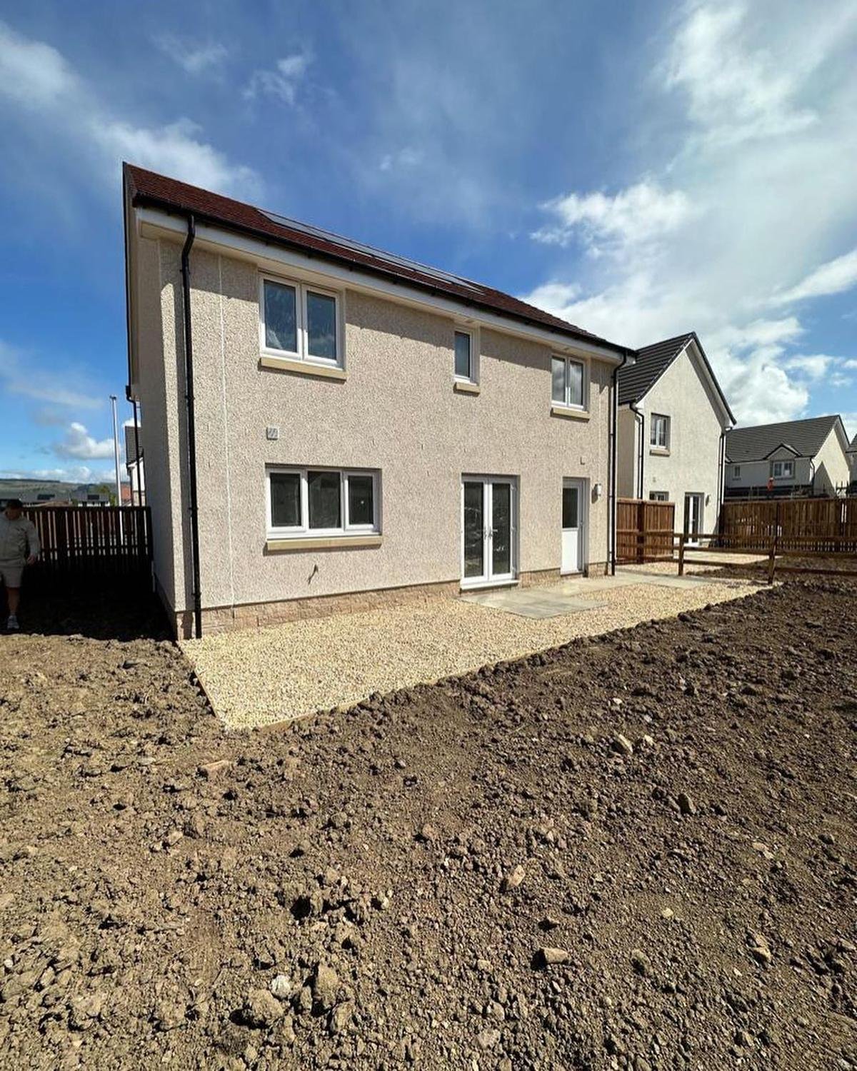 Before: a new-build house with an unlevelled garden of bare soil and gravel.